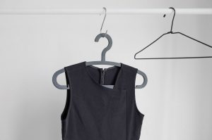 Black shirt hanging on a clothes hanger