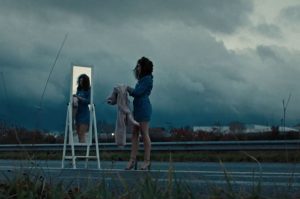 Lady trying on clothes on the highway