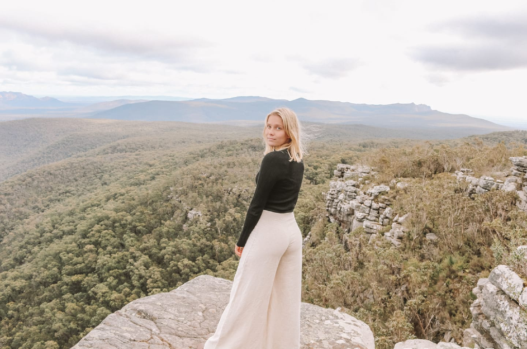 Woman in cream linen pants on mountain